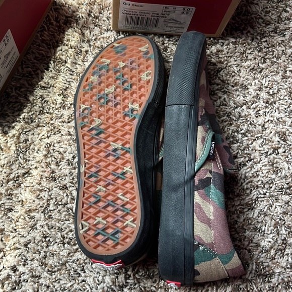 Vans and first pair are red and white and the other is black and green and brown - Picture 2 of 6